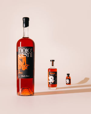 Large medium and small bottles of Negroni cocktail